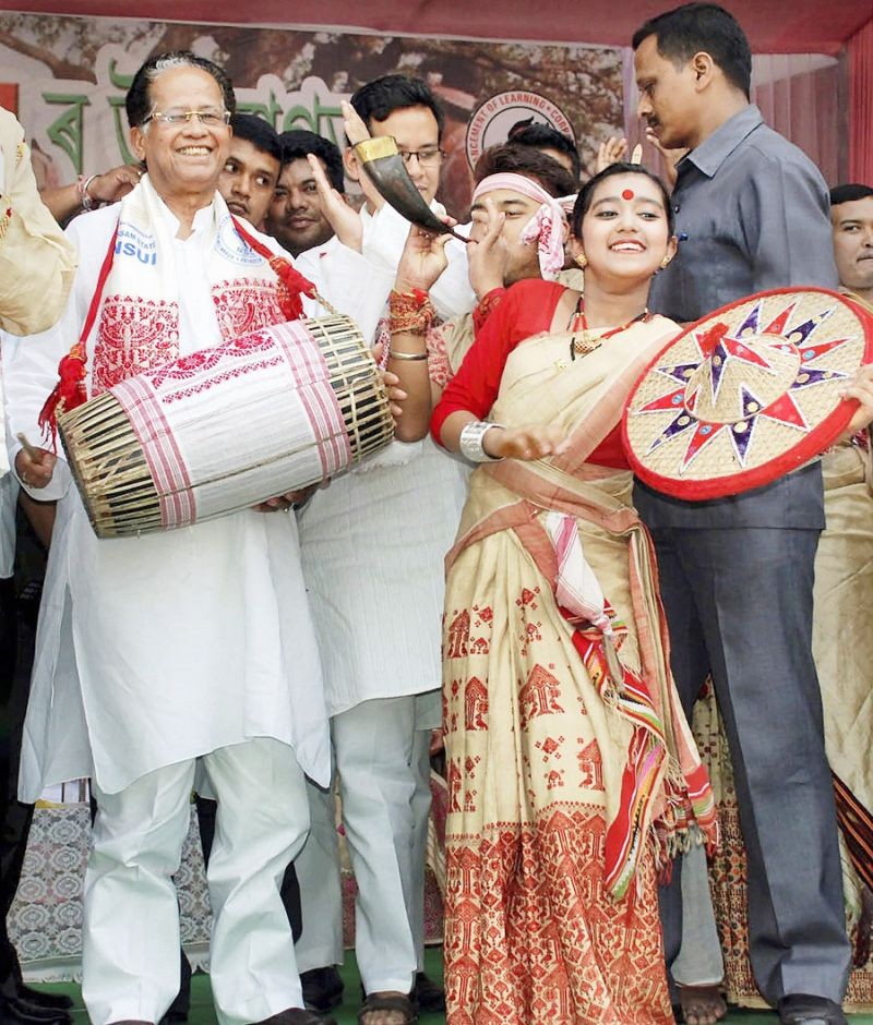 In this file photo dated April 13, 2013, then Chief Minister of Assam Tarun Gogoi beats a dhol during 'Sampriti Asom Utsav-2013' organized to mark the Rongali Bihu celebrations in Guwahati. (PTI File Photo)